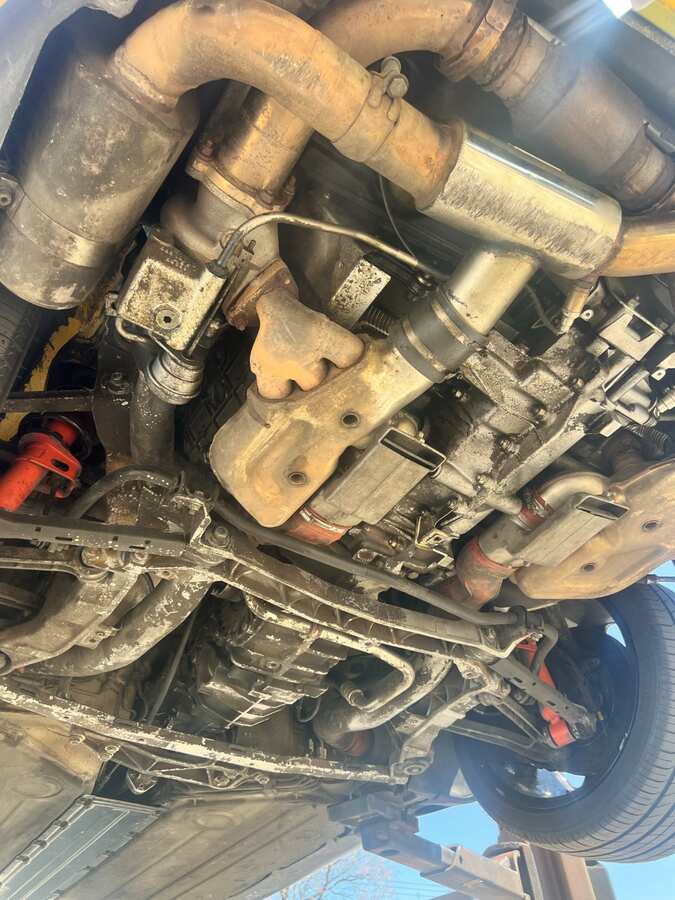 Porsche undercarriage before dry ice blasting — grease and road grime buildup