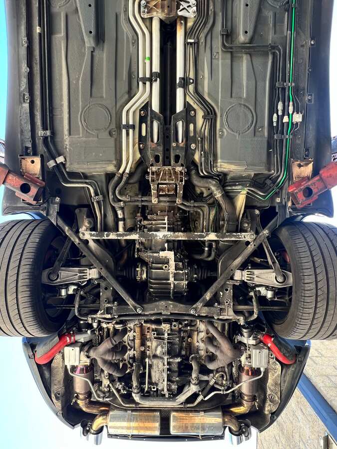 Exotic sports car chassis before dry ice blasting — contaminated and dirty