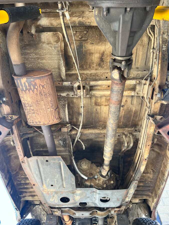 Truck undercarriage showing accumulated road grime before dry ice blasting